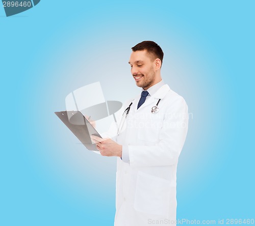 Image of smiling male doctor with clipboard and stethoscope