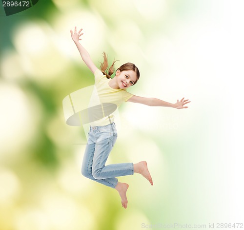 Image of smiling little girl jumping