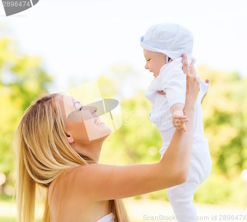 Image of happy mother with little baby in park