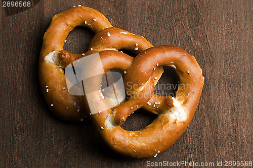 Image of Two typical bavarian pretzel on a brown background