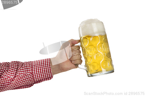 Image of Man in traditional Bavarian shirt holds mug of beer