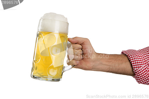 Image of Man in traditional Bavarian shirt holds mug of beer