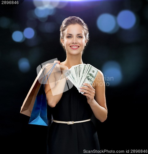 Image of smiling woman in dress with shopping bags