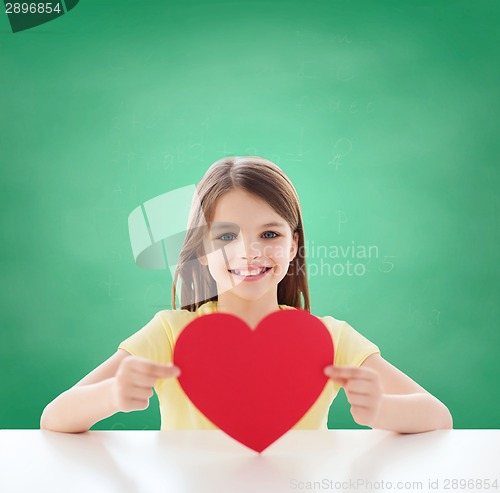 Image of beautiful little girl sitting at table