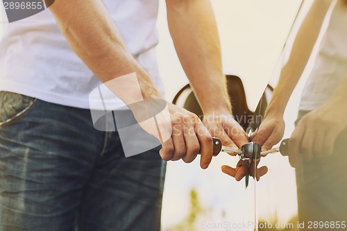 Image of man with car key outside