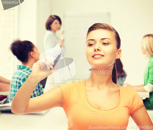 Image of student writing something in the air with marker