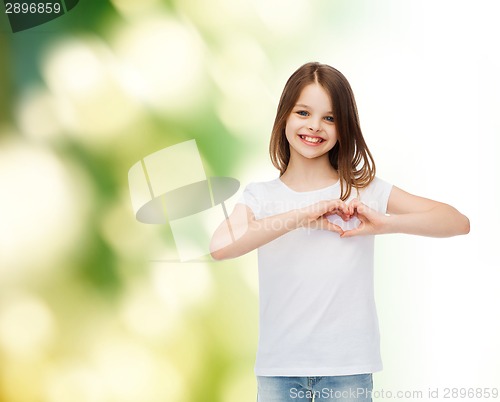 Image of smiling little girl in white blank t-shirt