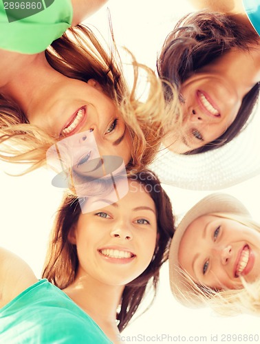 Image of faces of girls looking down and smiling