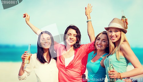 Image of girls with drinks on the beach