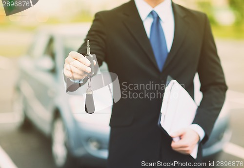 Image of man with car key outside