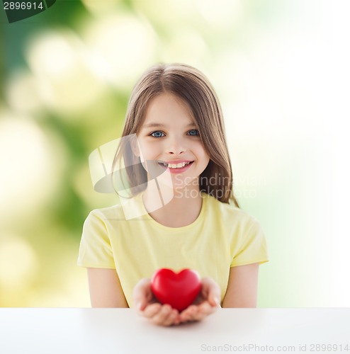 Image of beautiful little girl sitting at table