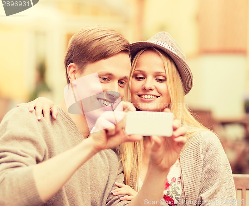 Image of couple taking selfie with smartphone