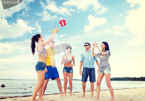 Image of group of friends having fun on the beach