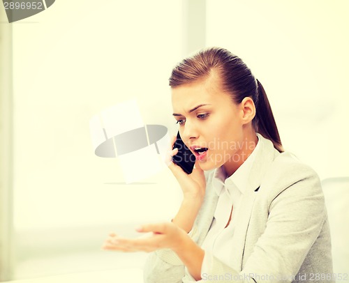 Image of woman shouting into smartphone