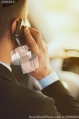 Image of man using phone while driving the car
