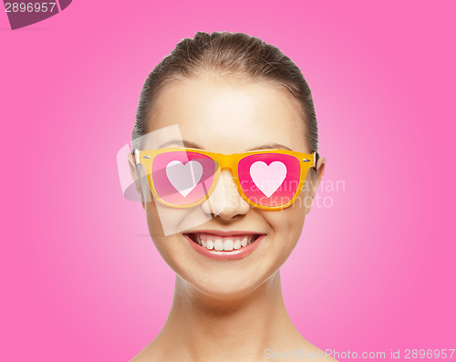 Image of smiling teenage girl in pink sunglasses