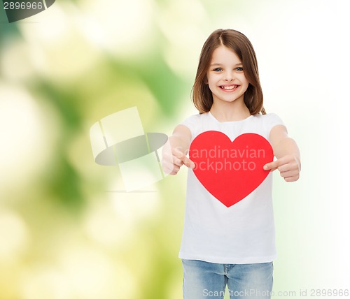 Image of beautiful little girl sitting at table
