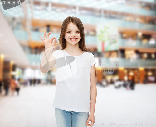 Image of smiling little girl in white blank t-shirt