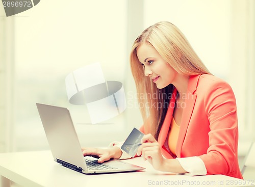 Image of businesswoman with laptop and credit card