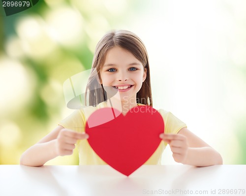 Image of beautiful little girl sitting at table