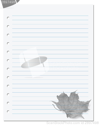 Image of Notebook paper with dry maple-leaf at background