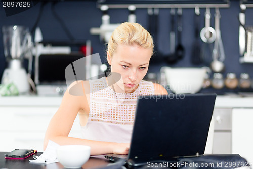 Image of Business woman working from home.