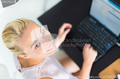 Image of Business woman working from home.