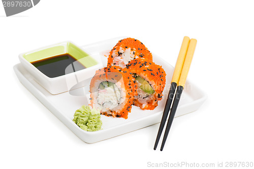 Image of Maki sushi rolls on the plate with chopsticks