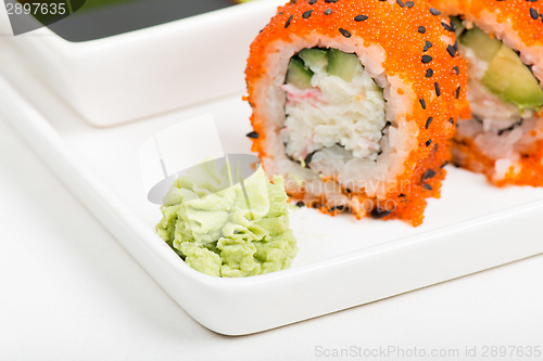 Image of Macro shot of wasabi with rolls on background