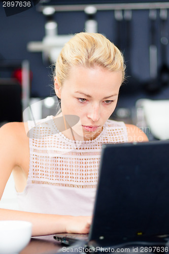 Image of Business woman working from home.