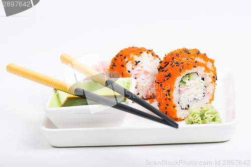 Image of Rolls on the plate with chopsticks
