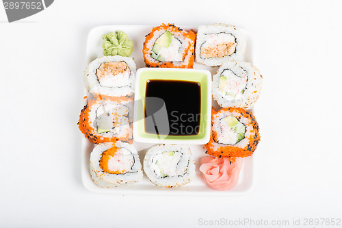 Image of Different sorts of sushi on the plate, top view