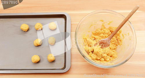 Image of Adding balls of cookie dough to a baking sheet