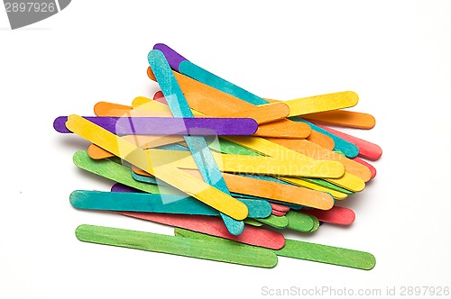 Image of pile of rainbow colored popsicle sticks