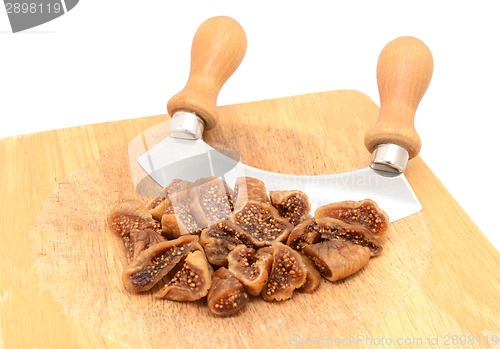 Image of Chopped soft dried figs with a rocking knife