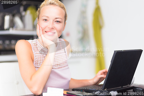 Image of Business woman working from home.