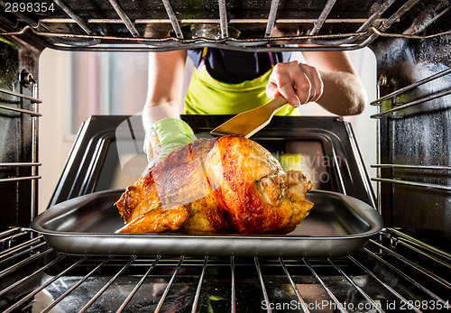 Image of Cooking chicken in the oven at home.