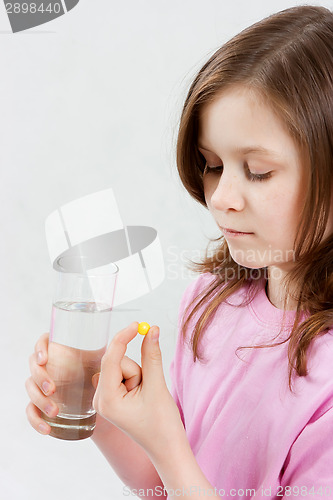 Image of Teen girl takes medicine