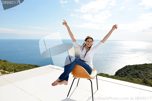 Image of relaxed young woman at home working on laptop