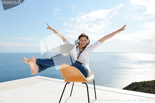 Image of relaxed young woman at home working on laptop