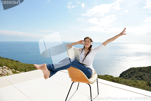 Image of relaxed young woman at home working on laptop