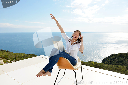 Image of relaxed young woman at home working on laptop