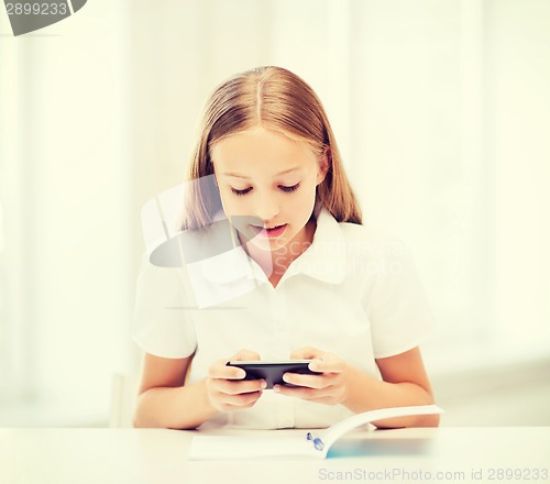 Image of girl with smartphone at school