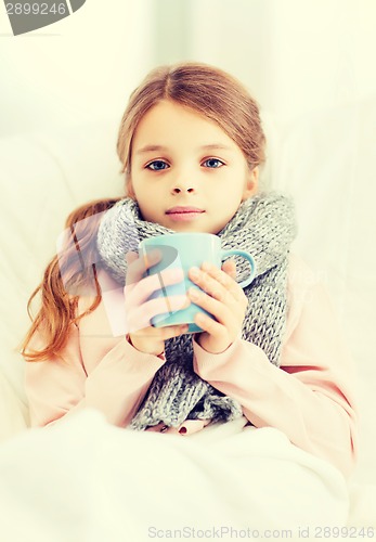 Image of ill girl child with cup of hot tea