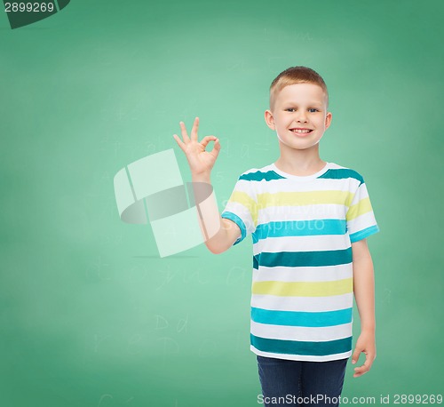 Image of little boy in casual clothes making OK gesture