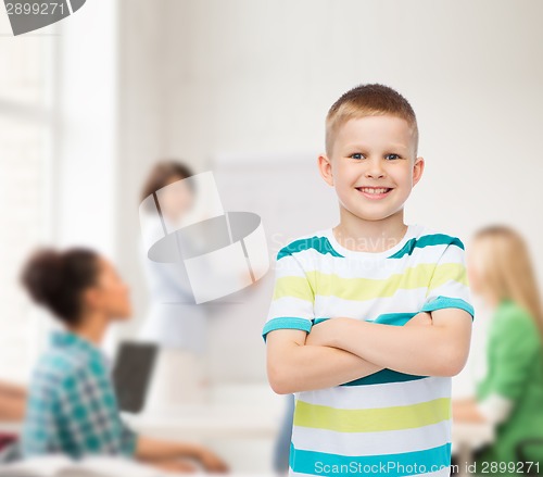 Image of little boy in casual clothes with arms crossed