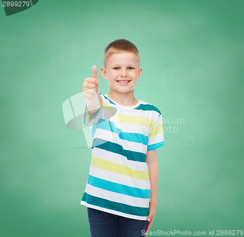 Image of little boy in casual clothes with arms crossed