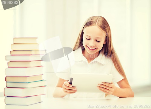 Image of girl with tablet pc and books at school