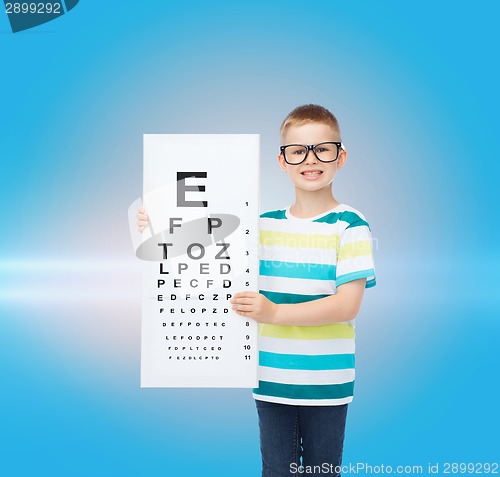 Image of smiling boy in eyeglasses with white blank board