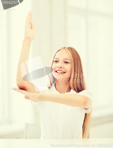 Image of student girl with hand up at school